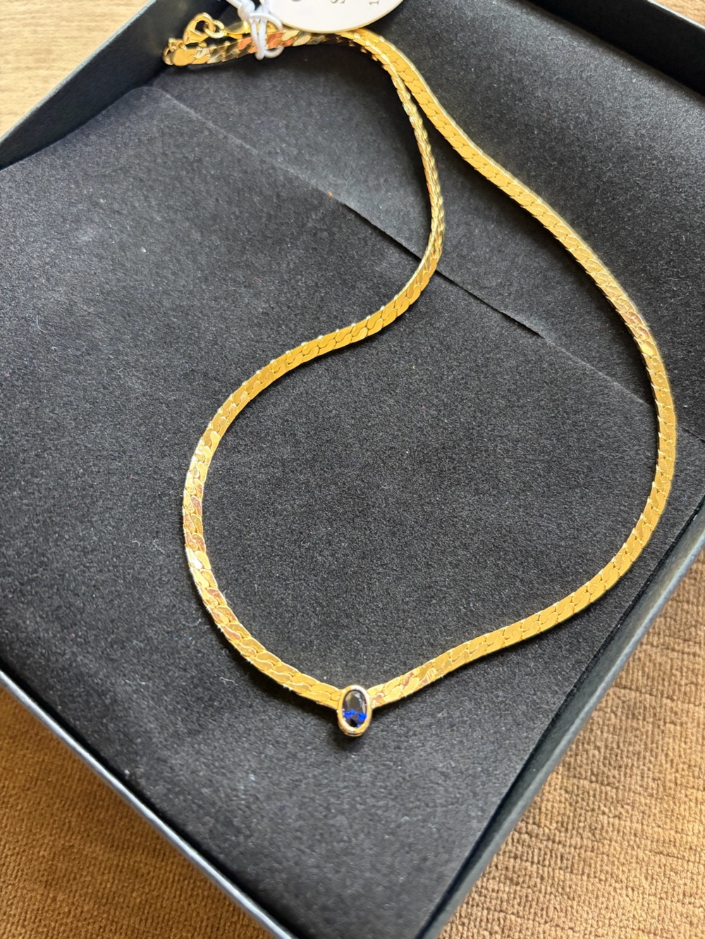 Gold necklace with sapphire gemstone pendant
